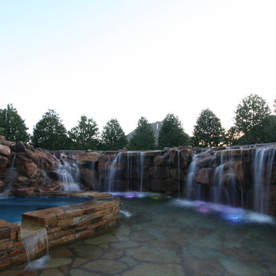 Inspiration for a small rustic backyard custom-shaped natural hot tub remodel in Oklahoma City