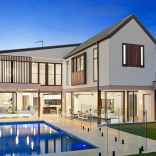 Mid-sized contemporary backyard rectangular lap pool in Melbourne with tile.