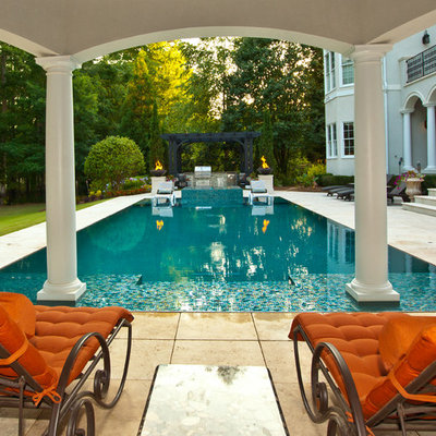 Inspiration for a large mediterranean backyard stone and rectangular infinity hot tub remodel in Other