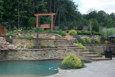 Pool - mid-sized backyard stamped concrete and kidney-shaped lap pool idea in Atlanta