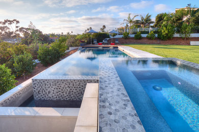 Inspiration for a mid-sized 1960s backyard concrete paver and custom-shaped infinity pool landscaping remodel in San Diego