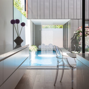 Design ideas for a contemporary courtyard rectangular lap pool in Melbourne with a water feature.