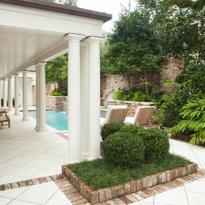 Inspiration for a mid-sized mediterranean backyard stamped concrete and rectangular lap pool fountain remodel in Miami