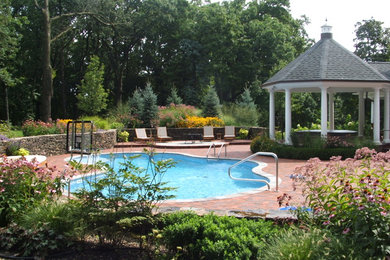 Inspiration for a timeless brick pool remodel in Chicago