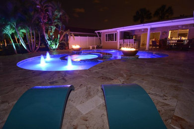 Example of a large trendy backyard custom-shaped lap hot tub design in Tampa