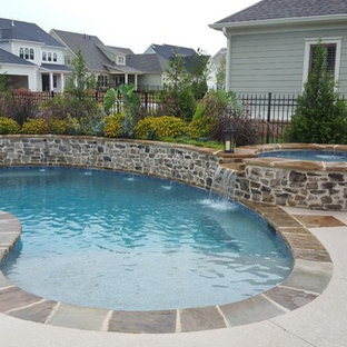 Mid-sized transitional backyard kidney-shaped natural pool in Atlanta with a hot tub and tile.