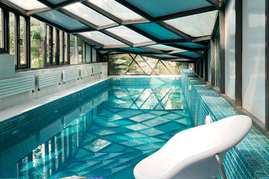 Imagen de piscina contemporánea de tamaño medio rectangular con suelo de baldosas
