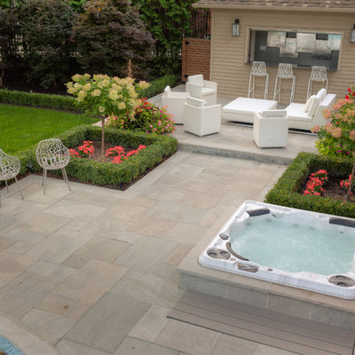 Inspiration for a large contemporary backyard stone and round lap hot tub remodel in Toronto
