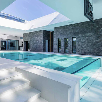 Modern indoor black and white pool with cement look porelain tile