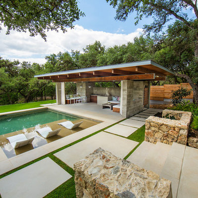 Large minimalist backyard stone and rectangular pool house photo in Austin