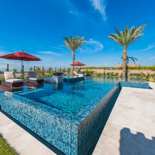 Ejemplo de piscinas y jacuzzis elevados, tropicales, en forma de L
