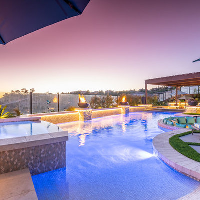 Hot tub - large contemporary backyard tile and custom-shaped lap hot tub idea in Orange County