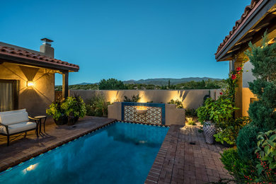 Mid-sized tuscan backyard brick and rectangular lap pool photo in Albuquerque