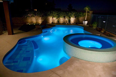 Immagine di una piscina moderna personalizzata di medie dimensioni e dietro casa con lastre di cemento