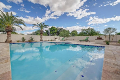 Large tuscan backyard stone and rectangular lap hot tub photo in Phoenix