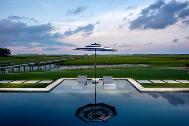 Mid-sized trendy backyard stone and custom-shaped pool house photo in Charleston