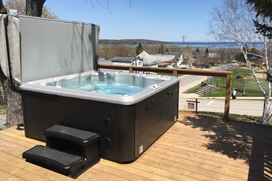 Photo of a classic hot tub in Toronto with decking.
