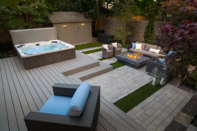 Modern back hot tub in Toronto with a shelter and decking.
