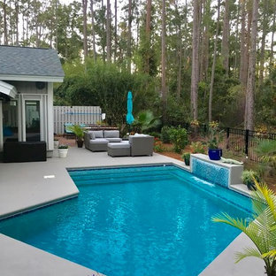 Mid-sized transitional backyard l-shaped lap pool in Atlanta with a water feature and decomposed granite.