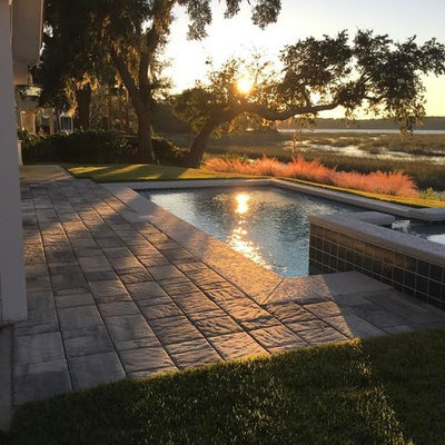 Mid-sized transitional backyard stamped concrete and rectangular lap hot tub photo in Atlanta