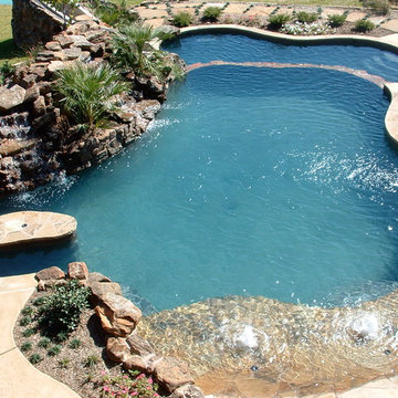 Natural Beach Entry Freeform Pool with slide, table and cascading waterfall