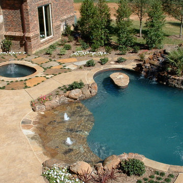 Natural Beach Entry Freeform Pool with slide, table and cascading waterfall