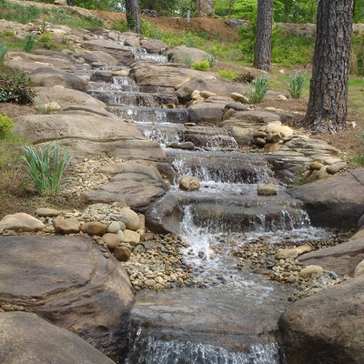 Inspiration for a huge rustic backyard stone and custom-shaped natural pool fountain remodel in Seattle