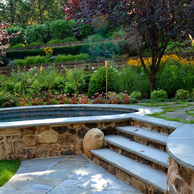Hot tub - mid-sized rustic backyard stone and kidney-shaped natural hot tub idea in Newark
