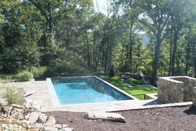 Pool - mid-sized farmhouse stone and rectangular natural pool idea in New York