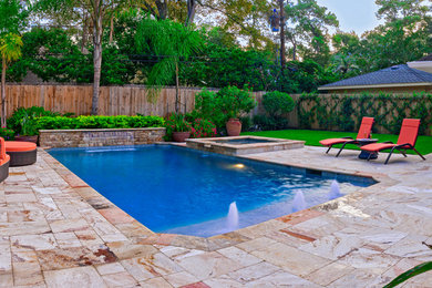 Inspiration for a mid-sized timeless backyard stone and rectangular pool fountain remodel in Houston