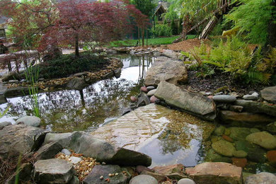 Photo of a large traditional backyard stone water fountain landscape in Atlanta.