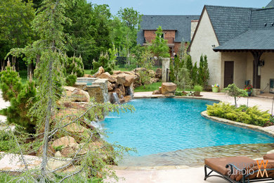 Inspiration for a mid-sized timeless backyard stone and kidney-shaped lap pool fountain remodel in Oklahoma City