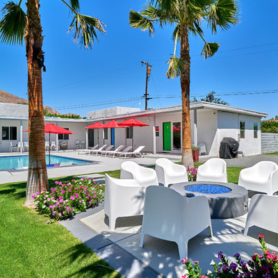 Mid-sized mid-century modern courtyard rectangular natural pool photo in Other