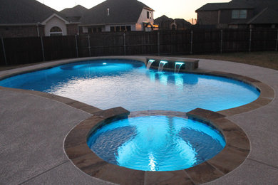 Pool - mid-sized backyard custom-shaped pool idea in Dallas with decking