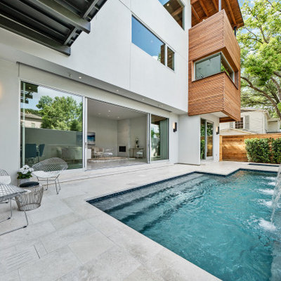 Example of a mid-sized trendy backyard stone and custom-shaped pool fountain design in Houston