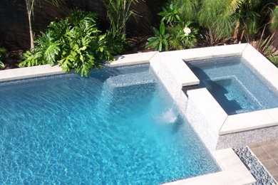 Inspiration for a mid-sized timeless backyard tile and rectangular lap hot tub remodel in Los Angeles