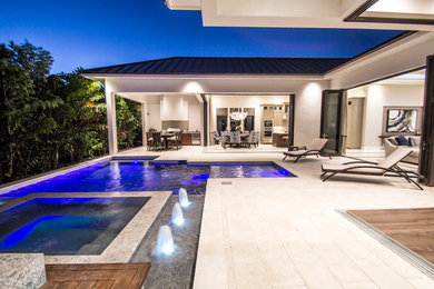 Inspiration for a large modern backyard custom-shaped and tile lap hot tub remodel in Miami