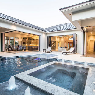 Hot tub - large modern backyard custom-shaped and tile lap hot tub idea in Miami
