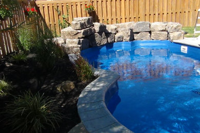 Example of a mid-sized classic kidney-shaped natural pool design in Toronto