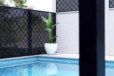 シドニーにある中くらいなコンテンポラリースタイルのおしゃれな裏庭プール (天然石敷き) の写真