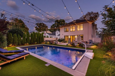 Pool - mid-sized contemporary backyard stamped concrete and rectangular lap pool idea in New York