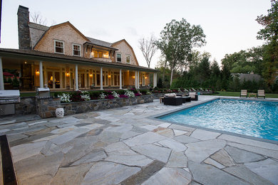 Elegant backyard rectangular and stone natural hot tub photo in New York