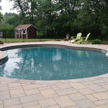 Oasis free form vinyl pool with paver deck