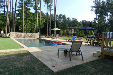 Pool fountain - mid-sized contemporary backyard stone and rectangular lap pool fountain idea in Raleigh