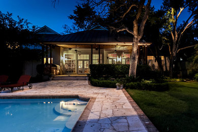 Mid-sized elegant backyard rectangular lap pool fountain photo in Austin