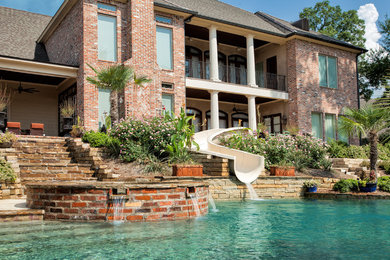 Inspiration for a backyard custom-shaped water slide remodel in New Orleans