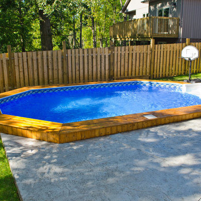 Mid-sized elegant backyard custom-shaped and concrete aboveground pool photo in Toronto
