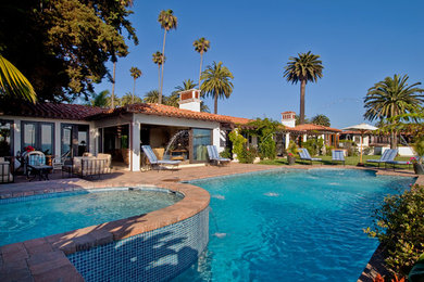 Large tuscan backyard rectangular pool photo in Orange County