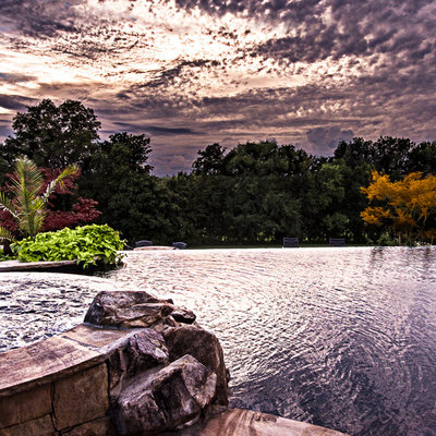 Example of a large mountain style backyard stone and custom-shaped natural pool fountain design in Nashville
