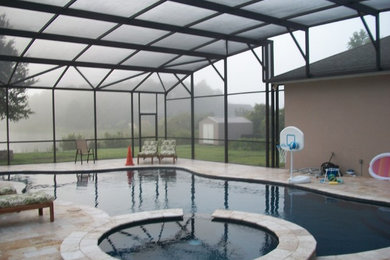 Island style pool photo in Orlando